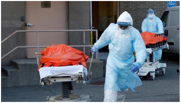 Healthcare workers wheel the bodies of deceased people from the Wyckoff Heights Medical Center during the outbreak of the coronavirus disease (COVID-19) in the Brooklyn borough of New York City, New York, U.S., April 4, 2020. REUTERS