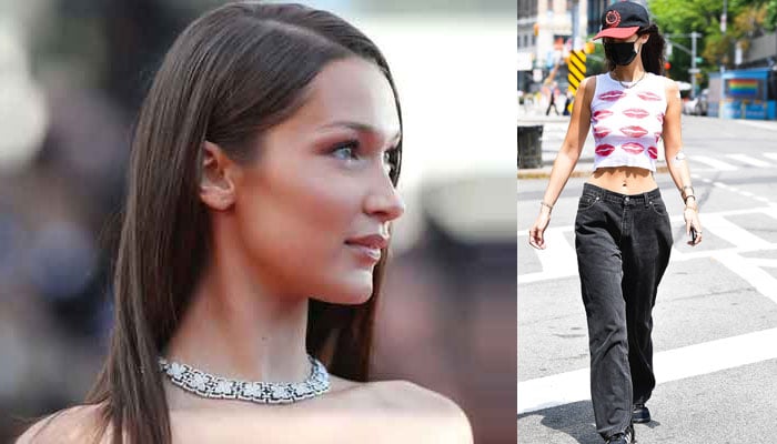 Bella Hadid showcases her toned abs in a kissy lips crop top during a walk in NYC