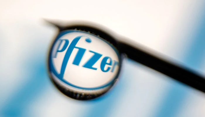 Pfizer logo is reflected in a drop on a syringe needle in this illustration photo taken March 16, 2021. — Reuters/File