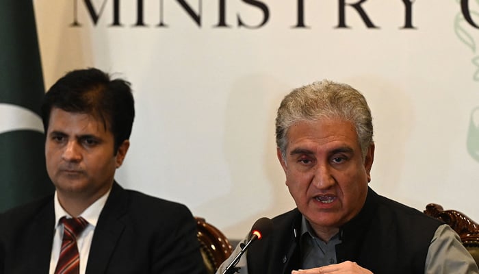 Foreign Minister Shah Mahmood Qureshi (R) and Javed Iqbal, chief of Counter-Terrorism Department of Khyber Pakhtunkhwa province attend a media briefing in Islamabad on August 12, 2021. — AFP