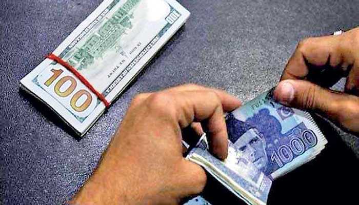 A currency trader counts Pakistani rupee notes as he prepares an exchange of dollars in Islamabad, Pakistan. Photo: Reuters