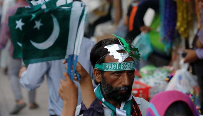 A man wears a mask and a headband as he sells patriotic merchandise ahead of Pakistans Independence Day, amid the coronavirus disease (COVID-19) pandemic, in Karachi, Pakistan August 11, 2021. -REUTERS