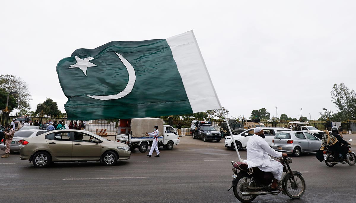 On August 14, 2021, in Karachi, Pakistan, during the coronavirus disease (COVID-19) pandemic, a man hoisted the national flag on his motorcycle to celebrate Independence Day.  — Reuters/Akhtar Soomro