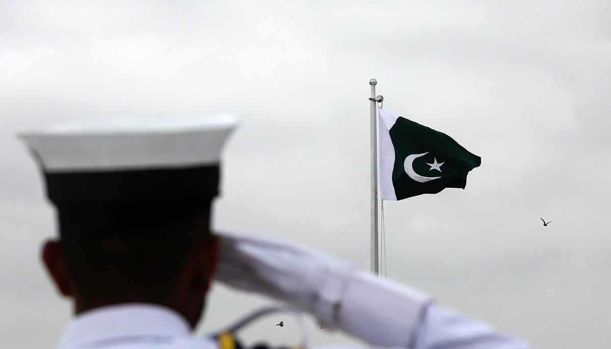 On August 14, 2021, a Pakistani navy cadet paid tribute to the national flag during a flag-raising ceremony to celebrate Independence Day at the mausoleum of Pakistani founder Quaid-e-Azam Mohammad Ali Jinnah in Karachi, Pakistan. — Reuters