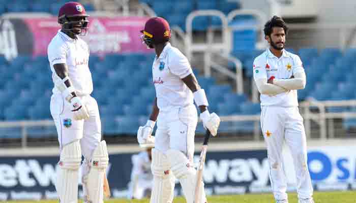 Hassan Ali (R) of Pakistan looks on as Jayden Seales (L) of the West Indies celebrate during day 4 of the 1st Test between West Indies and Pakistan at Sabina Park, Kingston, Jamaica, on August 15, 2021.