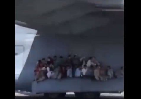 People clinging on to the wing of the aircraft before take-off — Twitter.