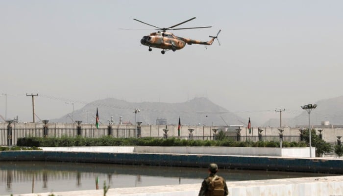A military helicopter carrying Afghan President Ashraf Ghani prepares to land near the parliament in Kabul, Afghanistan August 2, 2021. REUTERS/Stringer.