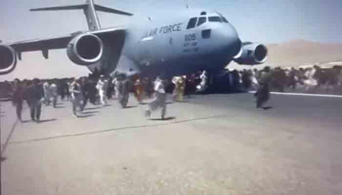 Screengrab shows desperate Afghans running alongside a US military plane taxing at the Kabul airport.