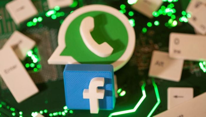 3D printed Facebook and WhatsApp logos and keyboard buttons are placed on a computer motherboard in this illustration taken January 21, 2021. Photo: Reuters