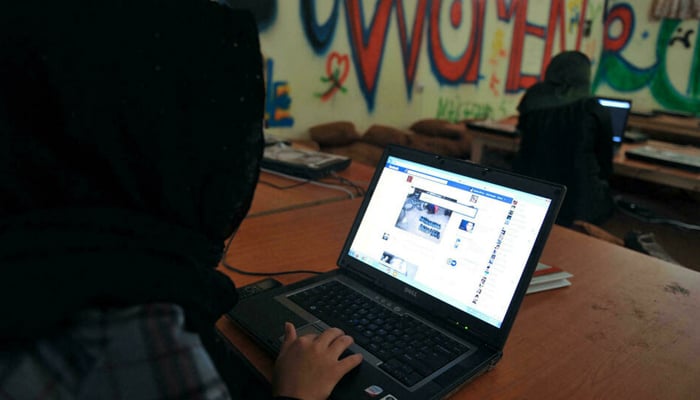 An Afghan woman browses Facebook at the Young Women For Change internet cafe, Afghanistans first women-only net cafe, in Kabul. — AFP/File