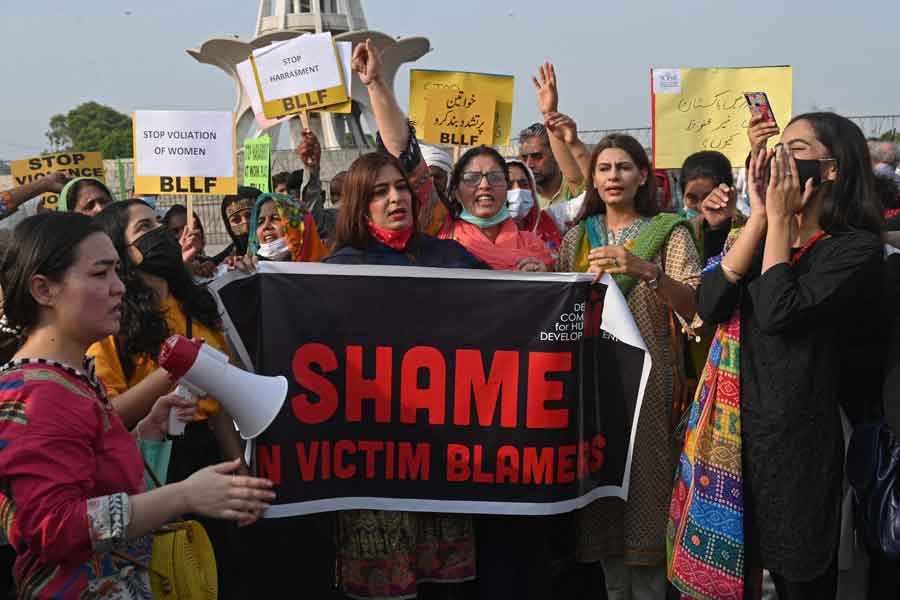 Human rights activists carry banner with shame on victim blamers inscribed, in a protest against the assault on a female TikToker by men in a public park on the eve of Pakistans Independence Day, in Lahore on August 21, 2021. —Photo by Arif Ali/AFP