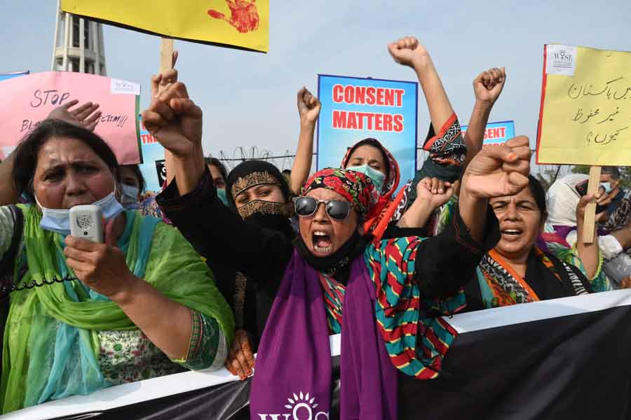 Human rights activists chant slogans in a protest against the assault on a female TikToker by men in a public park on the eve of Pakistans Independence Day, in Lahore on August 21, 2021. — Photo by Arif Ali/AFP