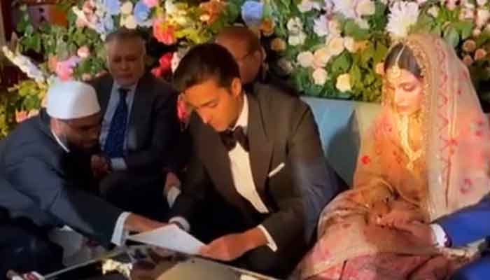 The groom, Junaid Safdar (centre), and the bride, Aisha Saif (right), during the nikah ceremony, at the Lanesborough hotel in London, on August 22, 2021. — Photo courtesy Twitter/Maryam Nawaz