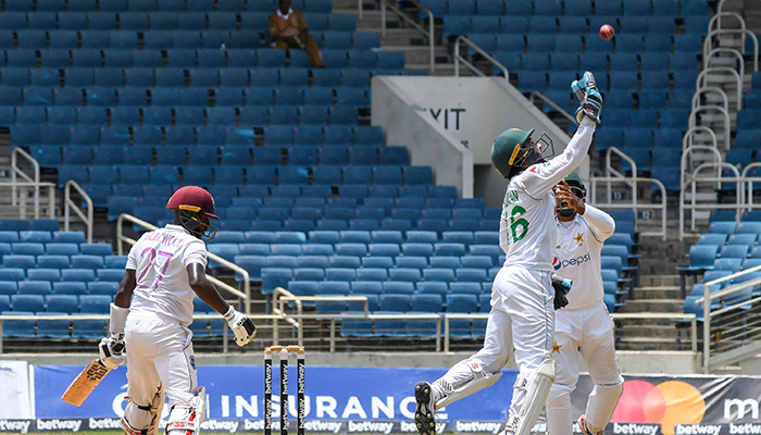 Mohammad Rizwan (R) of Pakistan celebrates taking the catch to dismiss Jermaine Blackwood (L) of West Indies during the 5th and final day of the 2nd Test between West Indies and Pakistan at Sabina Park, Kingston, Jamaica, on August 24, 2021. — AFP