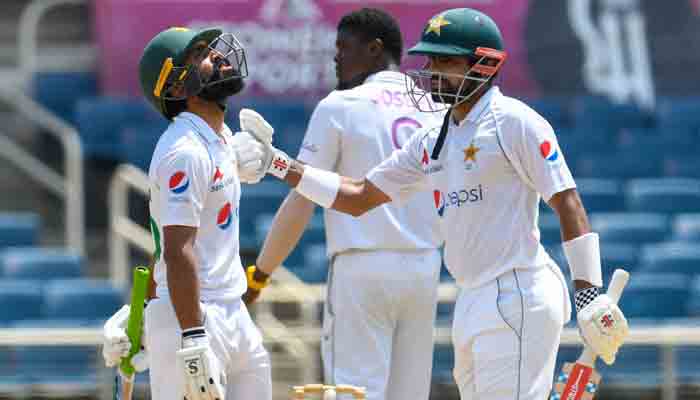 Fawad Alam (L) and Babar Azam (R) of Pakistan 100 partnership during day 1 of the 2nd Test between West Indies and Pakistan at Sabina Park, Kingston, Jamaica, on August 20, 2021.-AFP