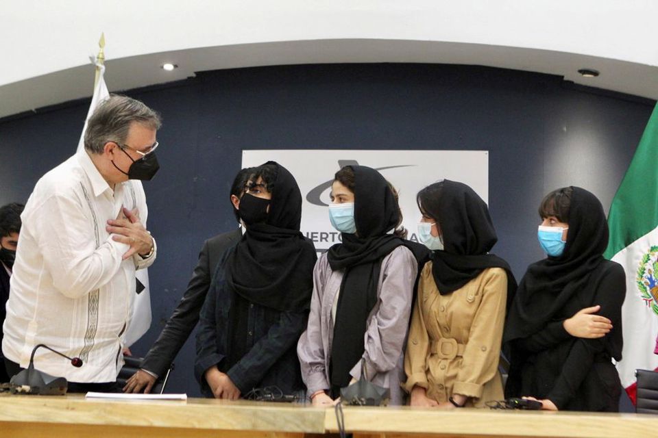 Mexicos Foreign Minister Marcelo Ebrard welcomes members of Afghanistans robotics team after arriving in Mexico to apply for humanitarian status, at the Benito Juarez International airport in Mexico City, Mexico August 24, 2021. Mexicos Foreign Relations Ministry/Handout via REUTERS