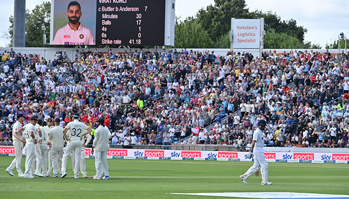 India´s captain Virat Kohli (R) walks back to the pavilion after getting out on the first day of the third cricket Test match between England and India at Headingley cricket ground in Leeds, northern England, on August 25, 2021. — AFP