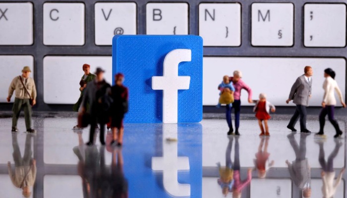 Illustration: A 3D printed Facebook logo is placed between small toy people figures in front of a keyboard. Taken April 12, 2020. REUTERS/Dado Ruvic