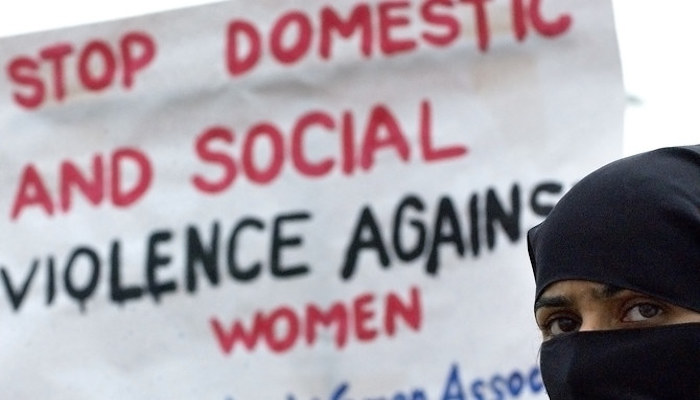 A Pakistani woman holds a placard as she marches with other activists of the Progressive Womens Association (PWA) during a demonstration near The Parliament House in Islamabad, Pakistan, on March 9, 2004. Photo: AFP