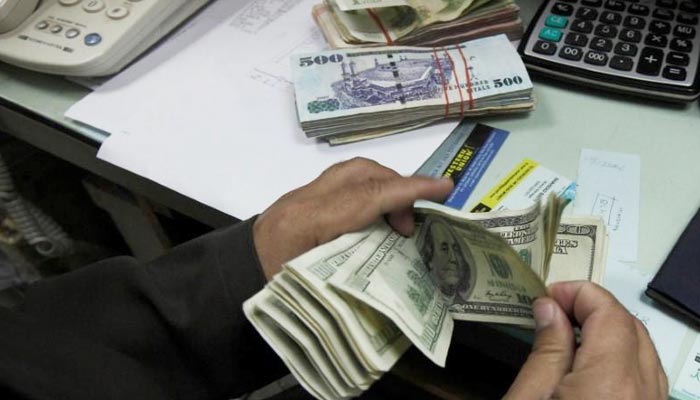 A currency exchange trader counts money at his office in Islamabad November 26, 2012. — Reuters/File