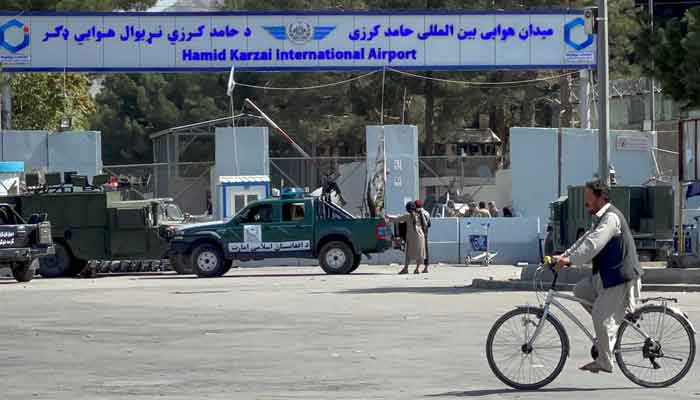 Taliban stand at the entrance gate of Hamid Karzai International airport while Taliban forces block the roads around the airport after yesterdays explosions in Kabul, Afghanistan August 27, 2021. — Reuters/Stringer