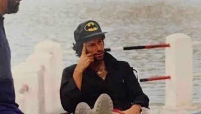 Prime Minister Imran Khan seen wearing a cap with what appears to be the 1992 batman logo, relaxing alongside a river in Skardu. — Photo courtesy Instagram/Imran Khan