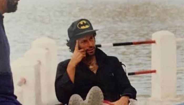 Prime Minister Imran Khanseen wearing a cap with what appears to be the 1992 batman logo, relaxing alongside a river in Skardu. — Photo courtesy Instagram/Imran Khan