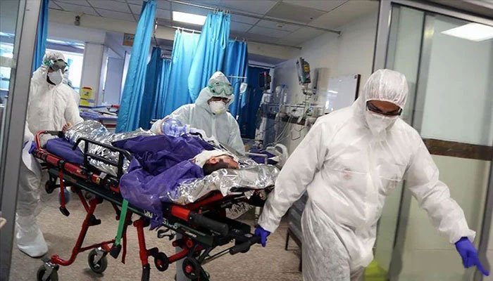 Doctors at a Pakistani hospital wheel away a patient on a bed. Photo: File