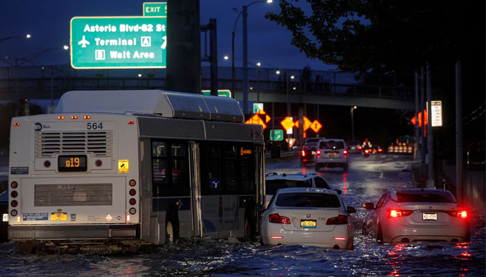 A bus navigates past abandoned cars on a flooded highway, as local media reported the remnants of Tropical Storm Ida bringing drenching rain and the threat of flash floods and tornadoes to parts of the northern mid-Atlantic, in the Queens borough of New York City, US, September 2, 2021. — Reuters/Brendan McDermid