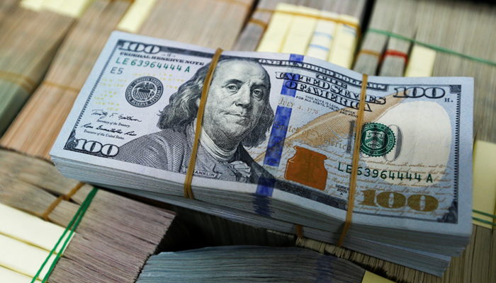 Picture showing a stack of 100-dollar bills sitting atop multiple stacks of notes. Photo: Reuters