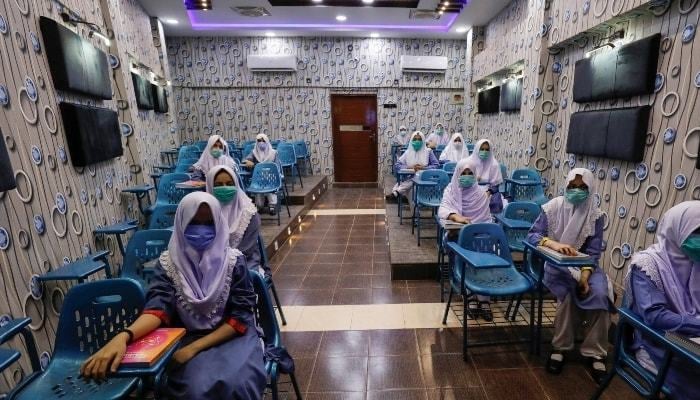 Students can be seen sitting in the examination hall — AFP