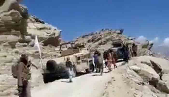 Still frame from an undated video seen by Reuters shows people with guns next to Humvees adorned with the Taliban flag on the mountaintops close to Golbahar, near the southern entrance of Panjshir valley, Afghanistan. Video obtained from social media.