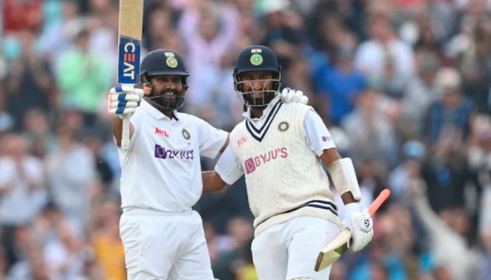 England batsman Rohit Sharma (left) raises his bat to acknowledge the crowd after scoring a heroic century against England. Photo: AFP