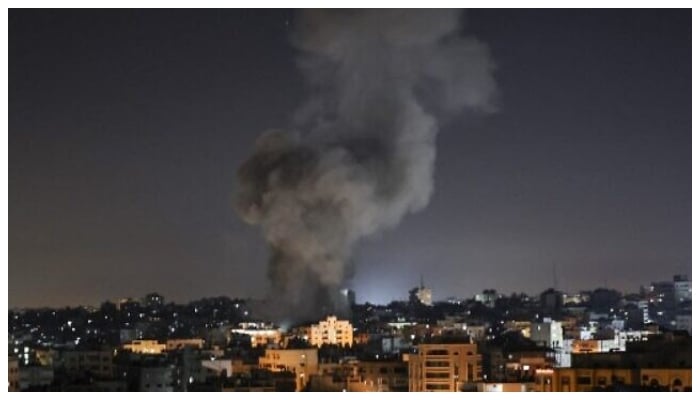 Smoke billows from a building in Gaza bombarded by Israeli jets. Photo: AFP