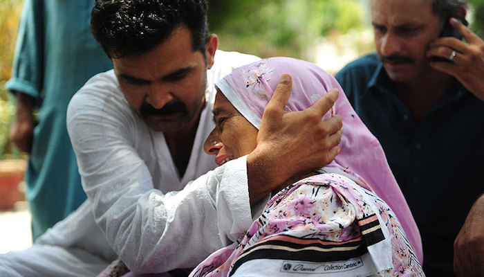 Pakistani relatives mourn missing family members following an assault by militants at Karachi airport terminal in Karachi on June 9, 2014. Photo: AFP