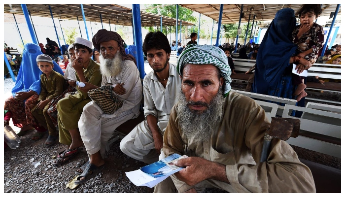 Afghan refugees wait to register at the UNHCR repatriation centre on the outskirts of Peshawar. Photo: AFP
