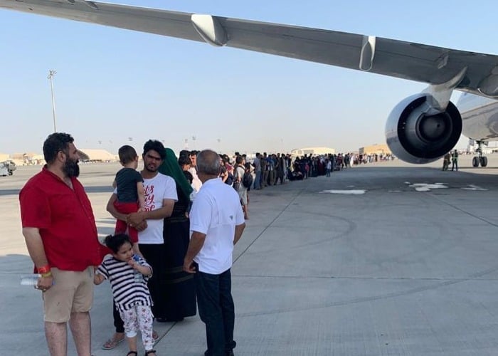 Afghan refugees stand in lines waiting to board the plane. Courtesy: Reema Khan/@iamreemakhan