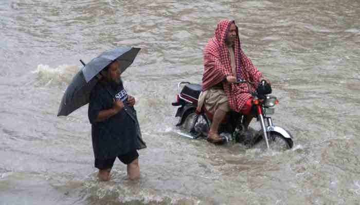 Man drives his bike amidst heavy rains in 2018. Courtesy: Reuters/File Photo