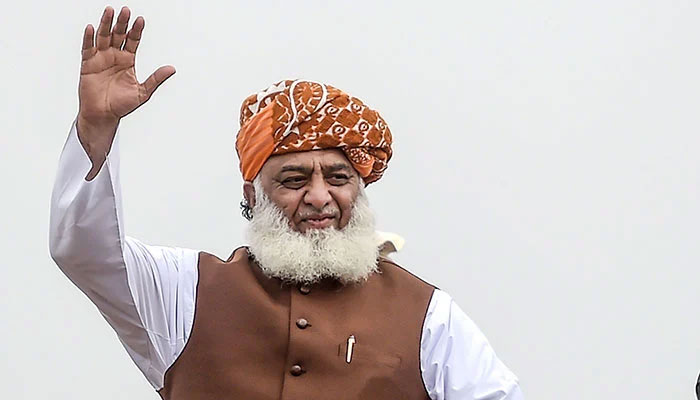 JUI-F chief Maulana Fazlur Rehman waves to a crowd of supporters. Photo: File