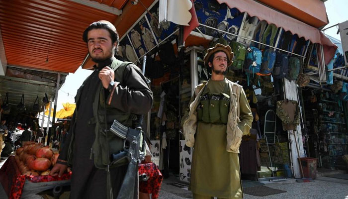 Some Taliban fighters arrive in Bush Market in Kabul to shop. AFP