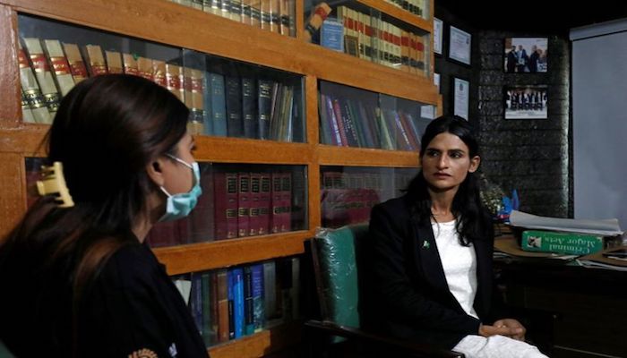 Nisha Rao, a transgender woman who became Pakistans first practicing lawyer, listens to one of her clients at an office in Karachi, Pakistan November 23, 2020. Photo: Reuters