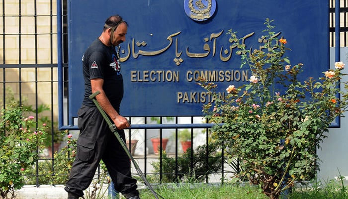 A Pakistan anti-terrorist force personal uses a metal detector to check the area of the Election Commission in Islamabad on August 26, 2008. — AFP/File