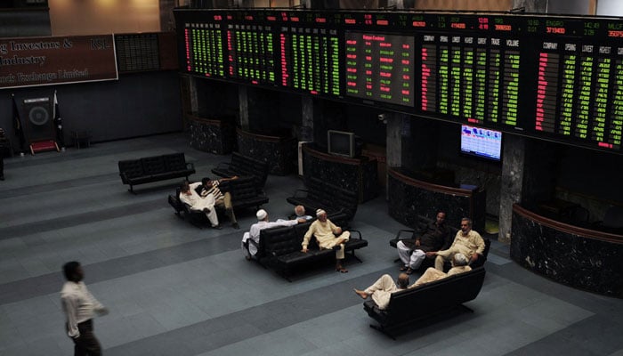 Investors can be seen sitting in the hall at The Pakistan Stock Exchange. — AFP/File