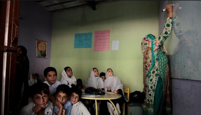 Students look out the door as their teacher writes on the board. September 26, 2017. Courtesy: Reuters.