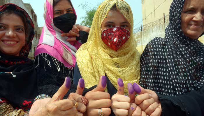 A group of women show off their inked thumbs after they cast their ballot at a polling station in Karachi, for cantonment board elections, on September 12, 2021. — The News/Zahid Rahman