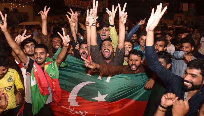 PTI supporters out celebrating on the streets in jubilation after the party won the elections in 2018. — AFP