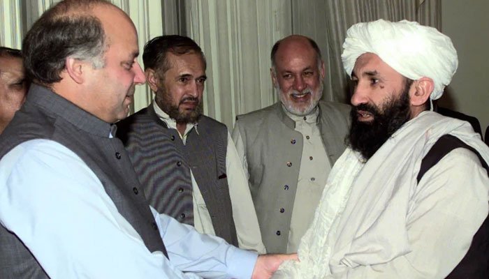 Former prime minister Nawaz Sharif shakes Mullah Hasan Akhunds hands. Photo: File