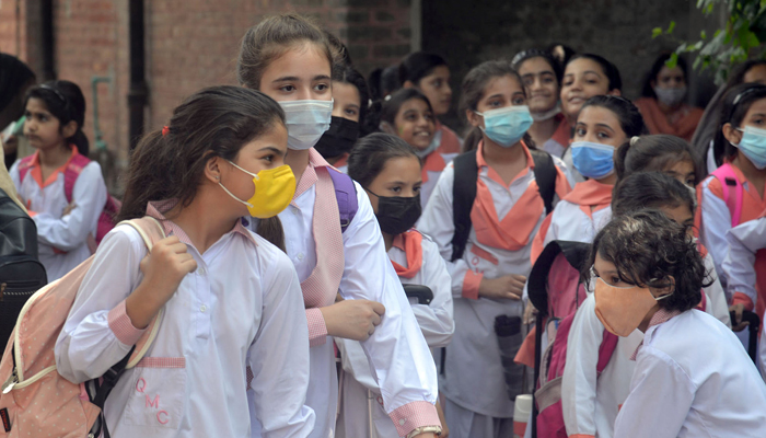 Students waiting for their school van in Lahore, on September 4, 2021. — Online/File