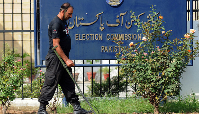 An anti-terrorist force personal uses a metal detector to check the area of the Election Commission of Pakistan in Islamabad on August 26, 2008. — AFP/File
