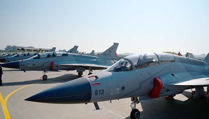 PAF personnel stand guard in front of 14 dual-seat JF-17B multi-role aircraft rolled out at a ceremony at the Pakistan Aeronautical Complex in Kamra. Photo: AFP